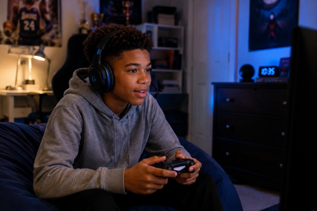 A teen with ADHD hyperfocused on a video game, showing how attention regulation differs by activity