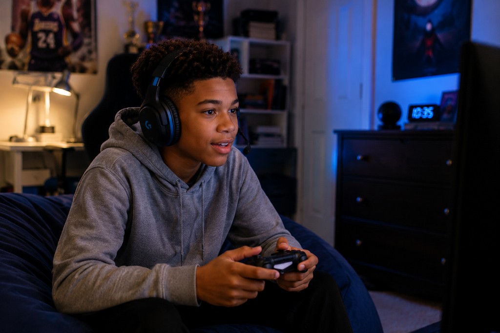 A teen with ADHD hyperfocused on a video game, showing how attention regulation differs by activity