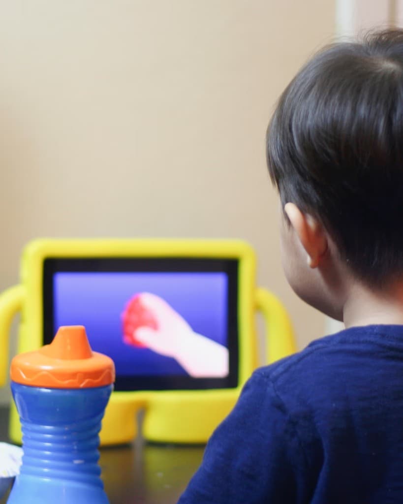 Child focused on a tablet activity at home