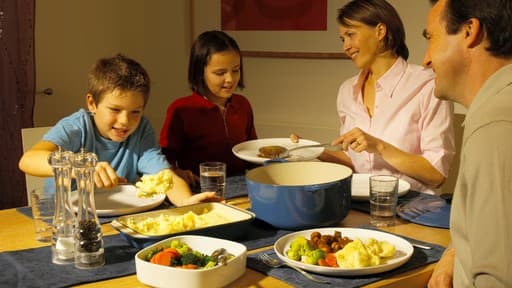 Family sharing a meal together at the dinner table