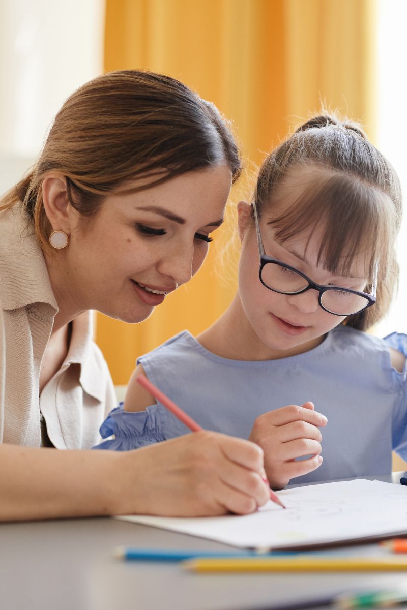 Adult and child drawing together at a table